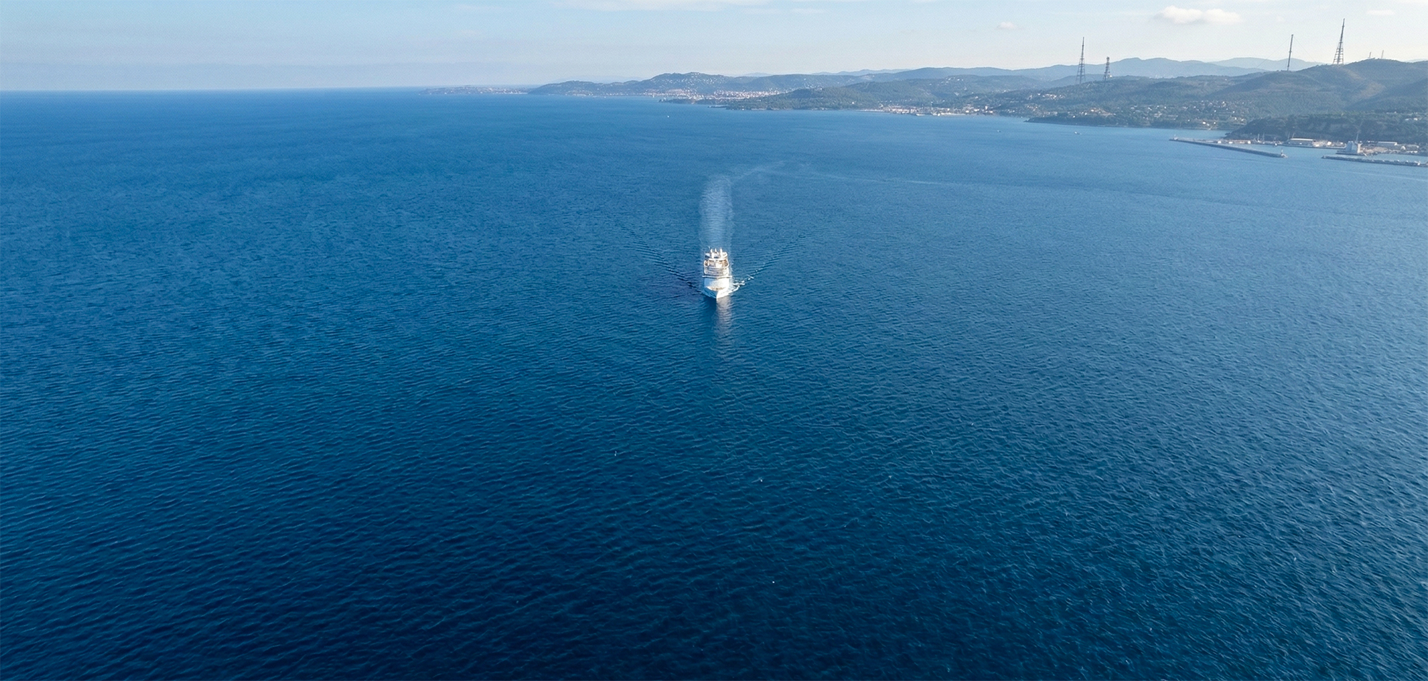 Cruise ship in the wide ocean but near land.