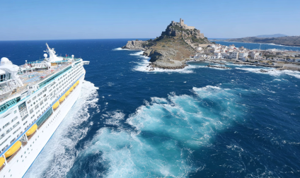 Mediterranean cruise ship near coast.